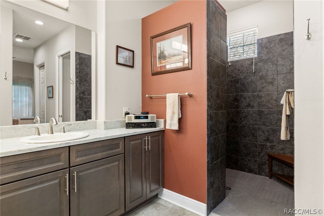 The easy walk-in shower is spacious and beautiful.