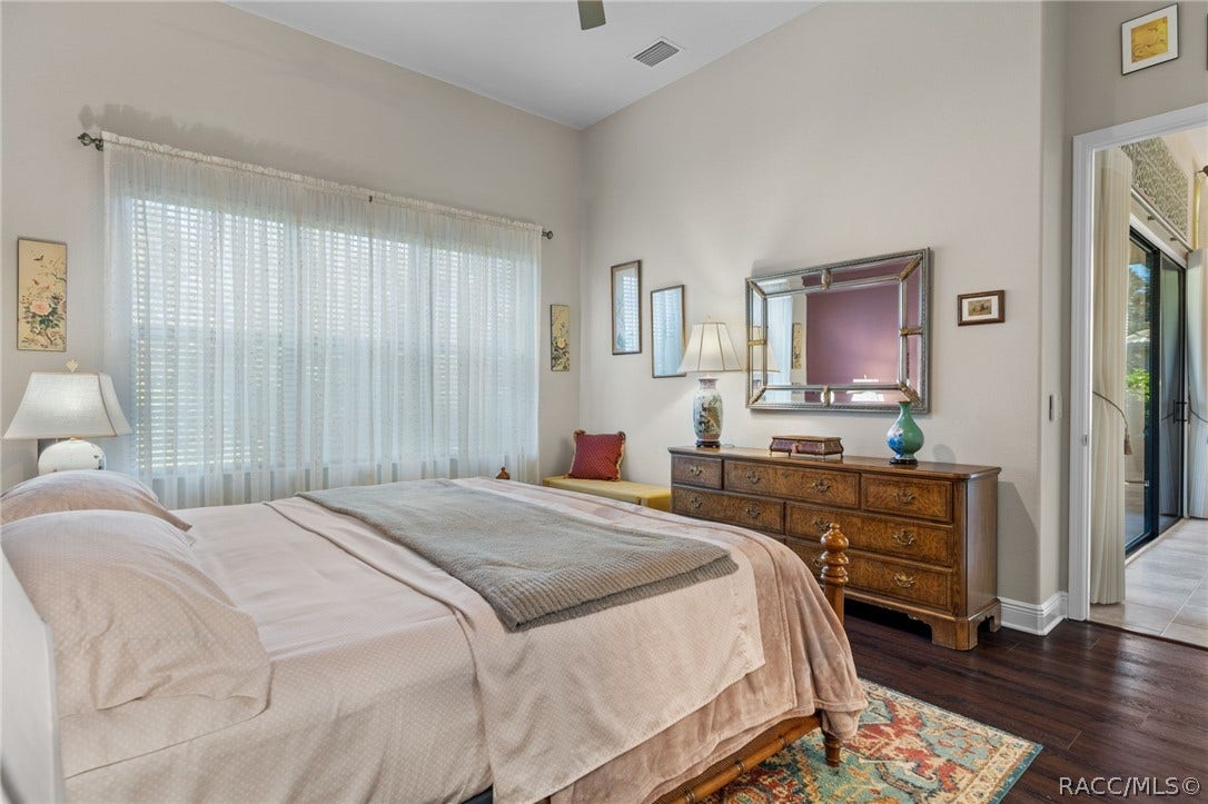 The spacious bedroom offers room for several pieces of furniture and overlooks the backyard.
