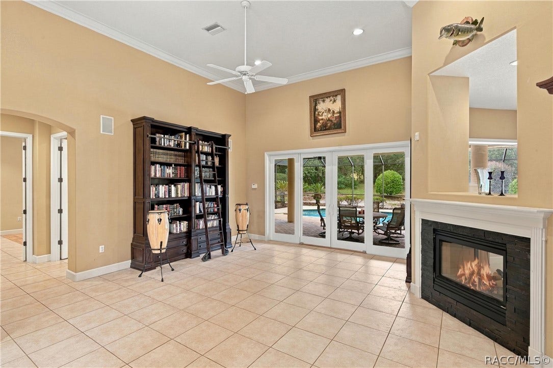 4605 N Pine Valley Loop, Lecanto, FL 34461 Living room with double sided fireplace