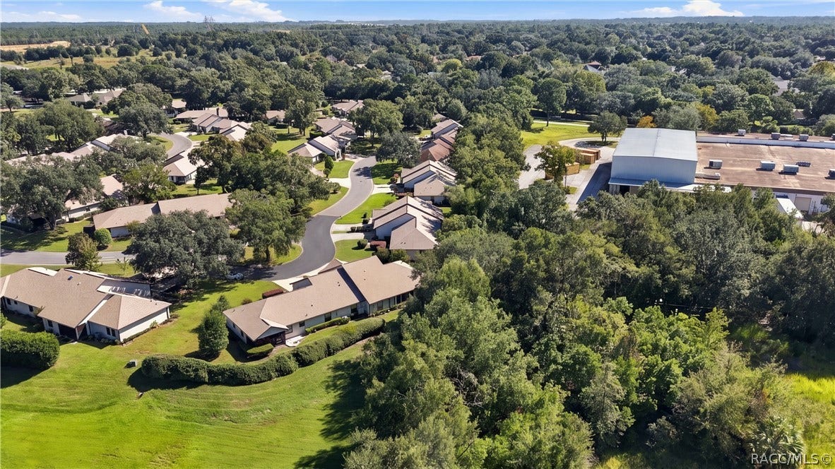 AERIAL VIEW OF SURROUNDING GREEN SPACE

An elevated view highlights the property's surrounding neighborhood, established landscaping, mature trees, and expansive nearby green space.
