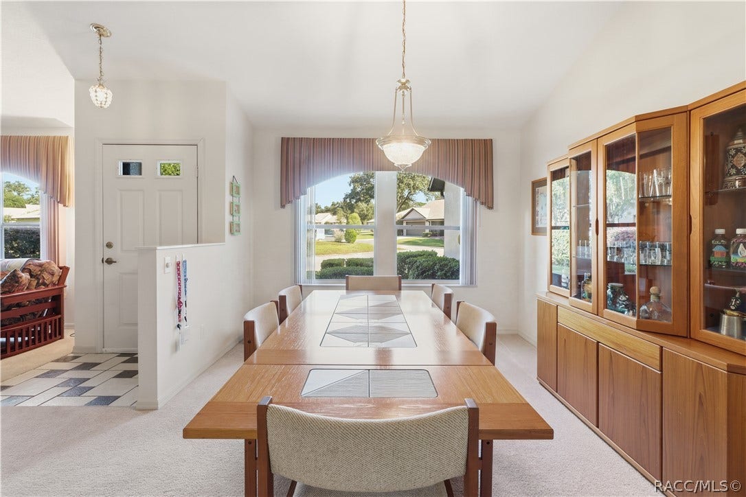 DINNER WITH A VIEW! FORMAL DINING ROOM features a beautiful front window, decorative chandelier & plenty of space for gathering around the table!