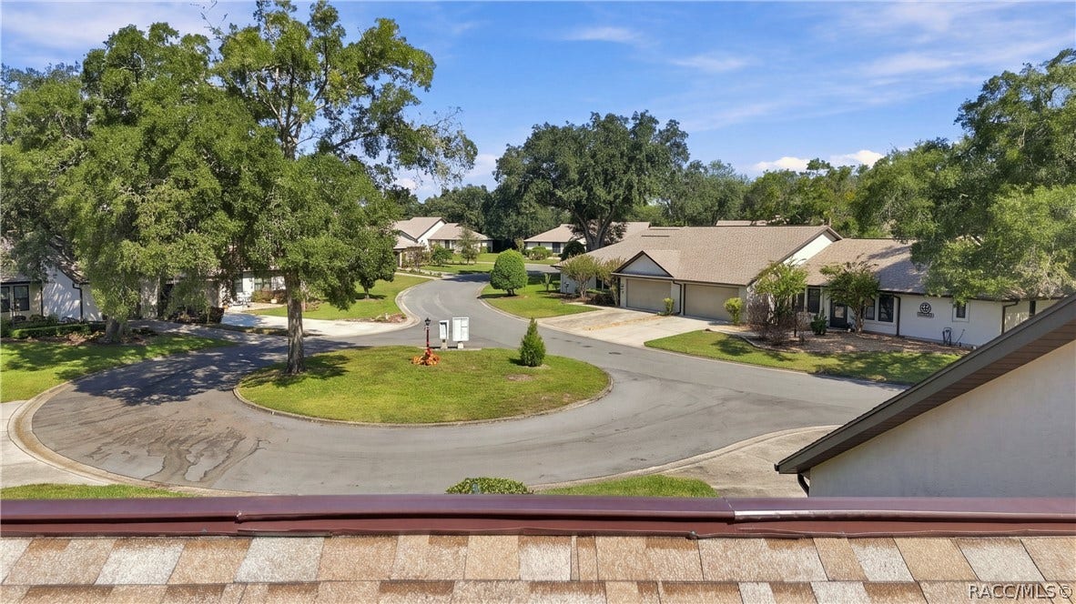 COMMUNITY CUL-DE-SAC VIEW

A bird's-eye view of the neighborhood's peaceful cul-de-sac setting, surrounded by mature shade trees, landscaped lawns, and neighboring residences.