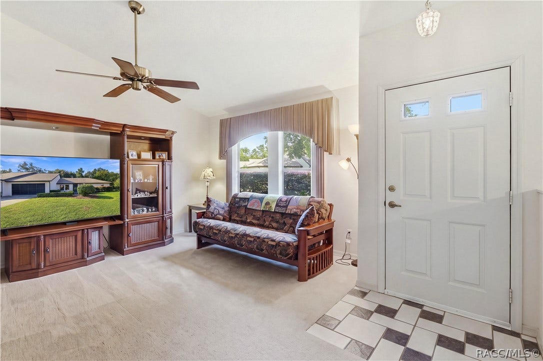 MAKE YOURSELF AT HOME! Bright & inviting LIVING ROOM w/VAULTED CEILINGS, CEILING FAN & large front window welcoming natural light!