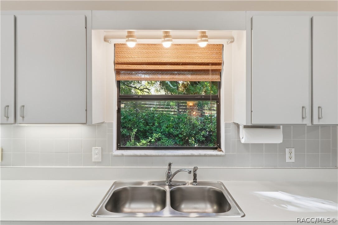 EVERYTHING IN ITS PLACE! Kitchen DOUBLE-BASIN STAINLESS STEEL SINK is perfectly positioned beneath a window overlooking the greenery!