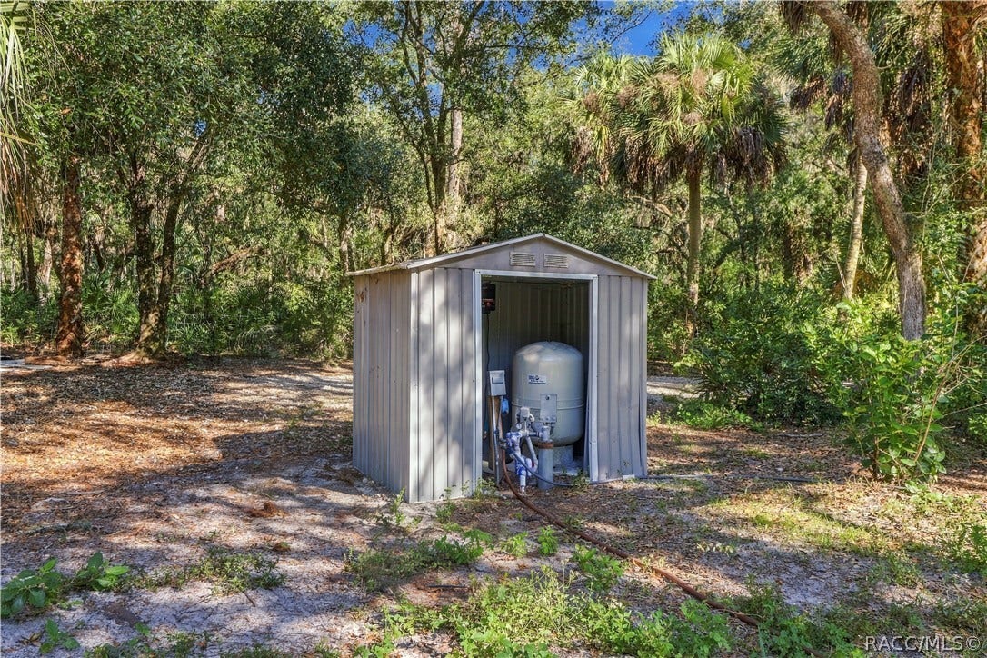 7528 N Chabaud Terrace, Crystal River, FL 34428 A PRACTICAL PROPERTY FEATURE! A separate enclosure houses the property's well equipment, surrounded by mature trees & natural vegetation.