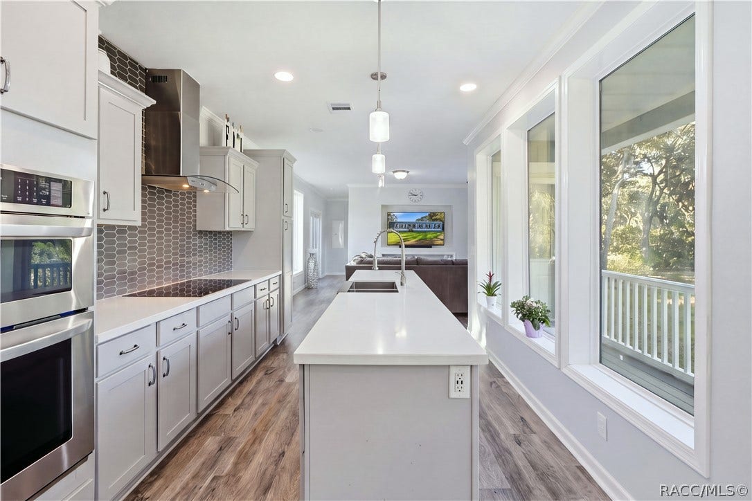 7528 N Chabaud Terrace, Crystal River, FL 34428 THE KITCHEN IS THE SHOWSTOPPER! Beautiful GRAY CABINETRY, expansive countertops, a generous CENTER ISLAND, stainless steel appliances & pendant lighting create an impressive gathering space.