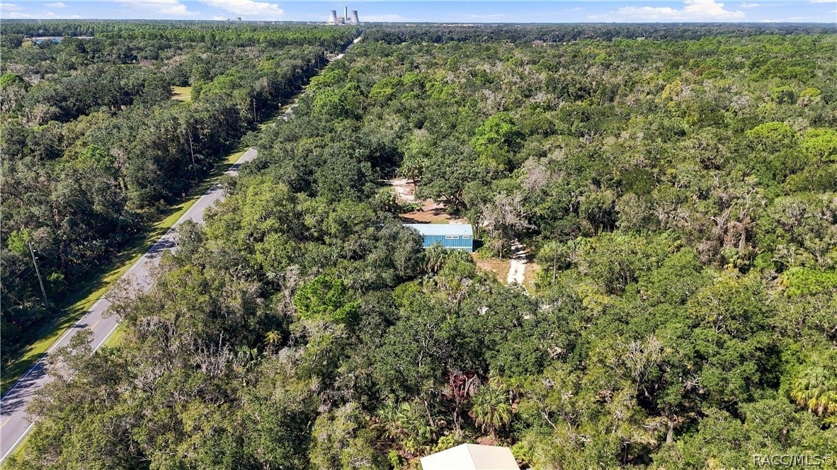 7528 N Chabaud Terrace, Crystal River, FL 34428 SURROUNDED BY NATURE! This expansive aerial view captures the home tucked among beautiful trees & the wooded character of the surrounding area.