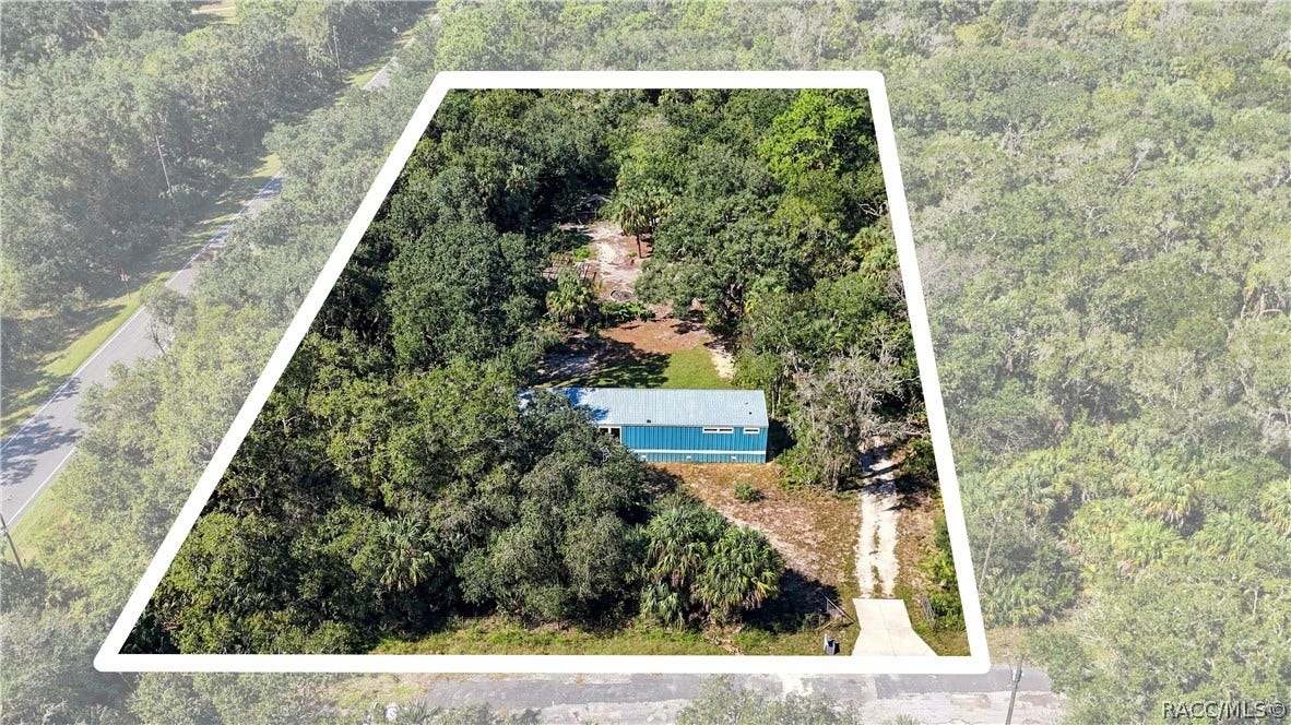 7528 N Chabaud Terrace, Crystal River, FL 34428 AERIAL PROPERTY VIEW: A beautiful look at the 1.42 FULLY FENCED ACRES w/GATED ENTRANCE, surrounded by mature trees, Florida palms & natural greenery. Room to enjoy the outdoors!
