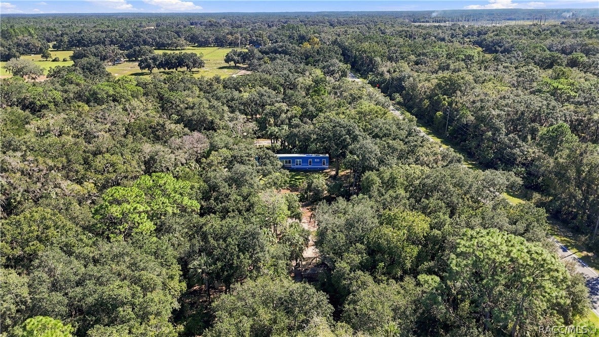 7528 N Chabaud Terrace, Crystal River, FL 34428 FLORIDA'S NATURAL BEAUTY! Another stunning aerial perspective showcases the surrounding tree canopy, lush vegetation & peaceful, wooded setting.