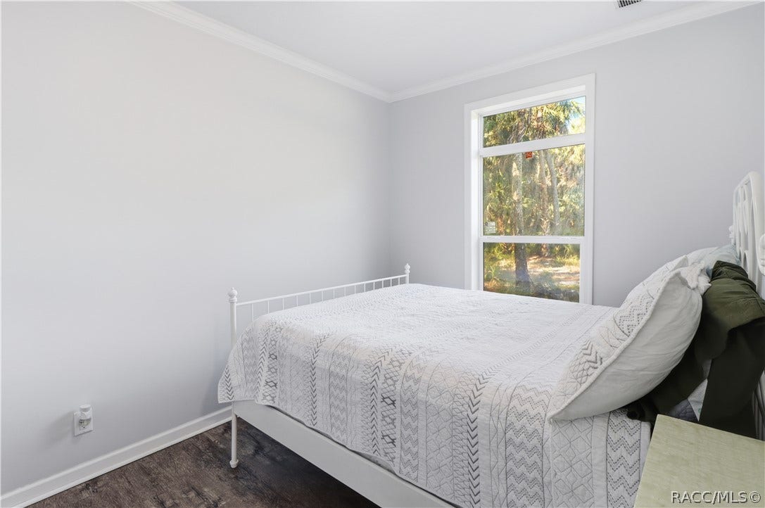 7528 N Chabaud Terrace, Crystal River, FL 34428 WAKE UP TO NATURE! Another view of the bedroom showcases natural light, attractive flooring & peaceful views of the surrounding trees.
