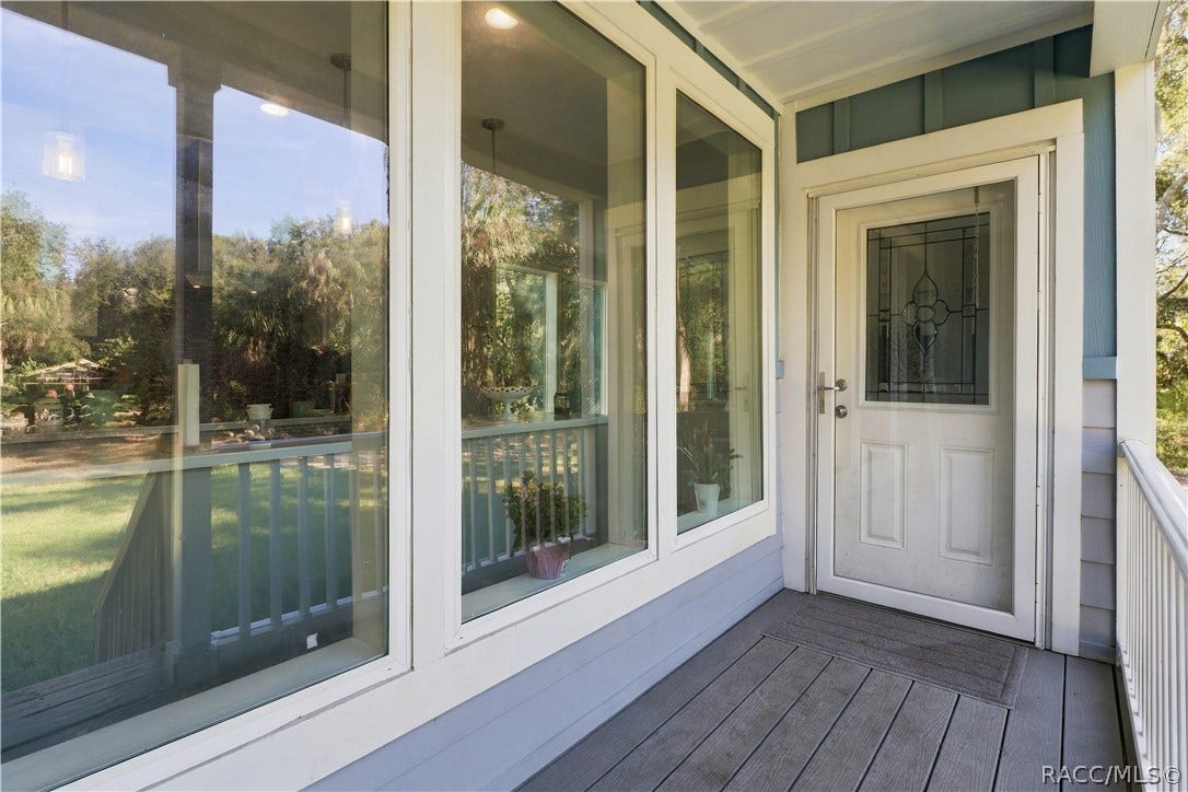7528 N Chabaud Terrace, Crystal River, FL 34428 A WELCOMING FIRST IMPRESSION! The covered entry features attractive windows, white railings & a decorative glass front door that adds character.