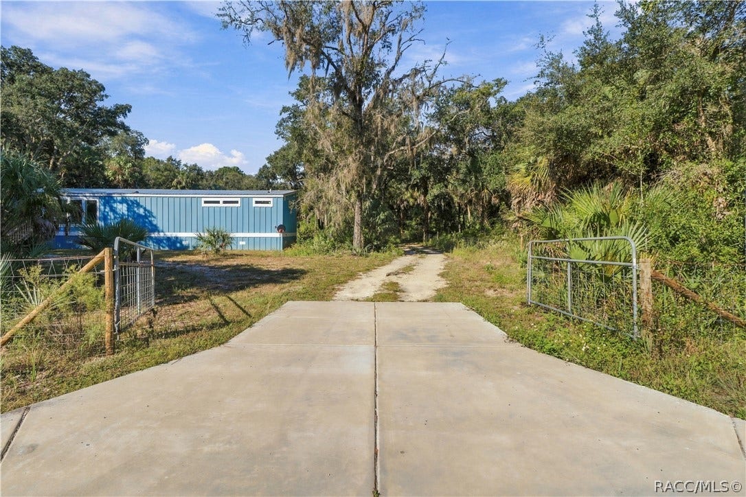 7528 N Chabaud Terrace, Crystal River, FL 34428 A GATED ENTRANCE WELCOMES YOU! The concrete driveway apron leads through a gated entrance into the 1.42 FULLY FENCED ACRES, offering space for vehicles & outdoor toys.