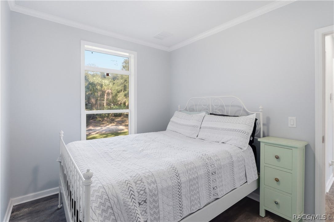7528 N Chabaud Terrace, Crystal River, FL 34428 A PEACEFUL PLACE TO UNWIND! This inviting BEDROOM features soft neutral colors, attractive flooring, crown molding & a large window overlooking the beautiful natural surroundings.