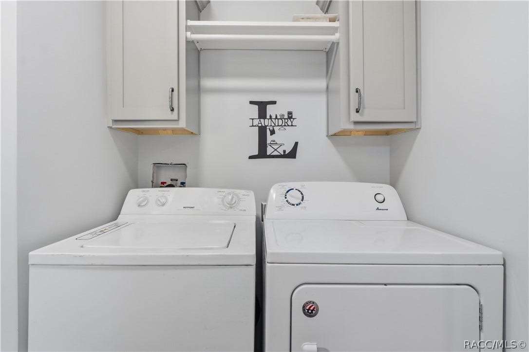 7528 N Chabaud Terrace, Crystal River, FL 34428 LAUNDRY MADE CONVENIENT! The INDOOR LAUNDRY AREA features a washer, dryer, overhead GRAY CABINETRY & shelving for additional storage.