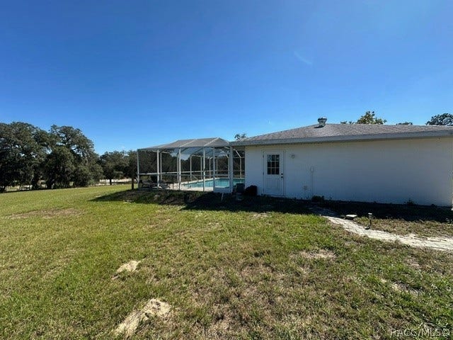 3409 W Corrie Leath Lane, Dunnellon, FL 34433 Detached garage with caged pool