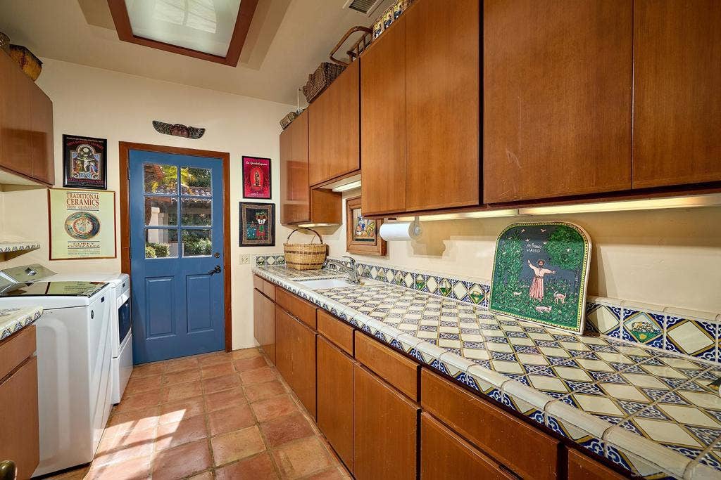 Laundry with access to the patio and pool.