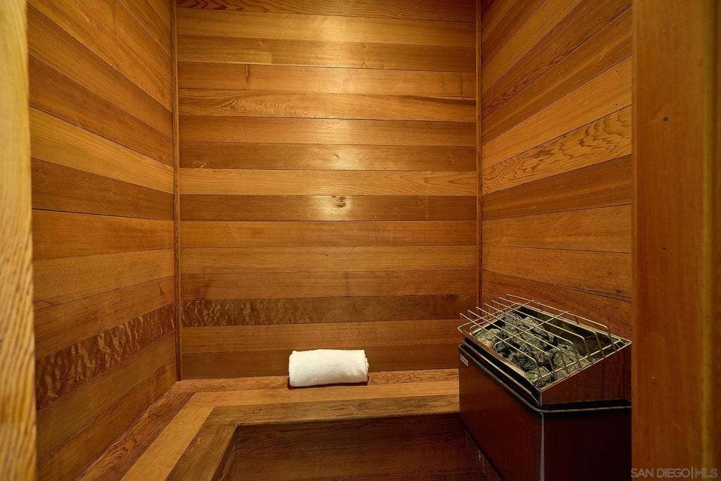 The gents bath includes a walk-in closet, a wood burning fireplace and a sauna.