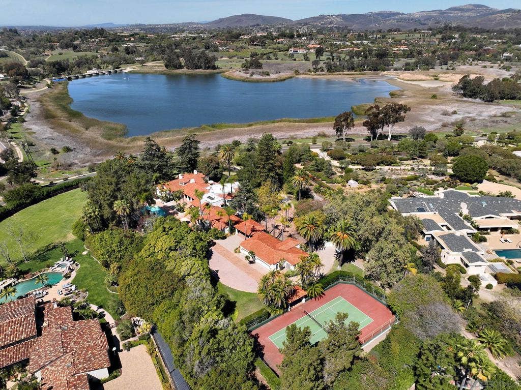 Majestic views of the lake from the pool, patios, and throughout the house.