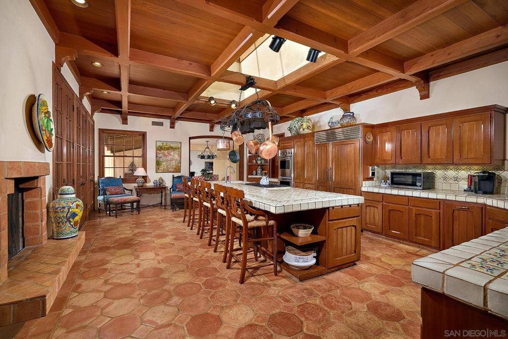 Gourmet kitchen with custom cabinetry, expansive Mexican-tiled island and butlers pantry.