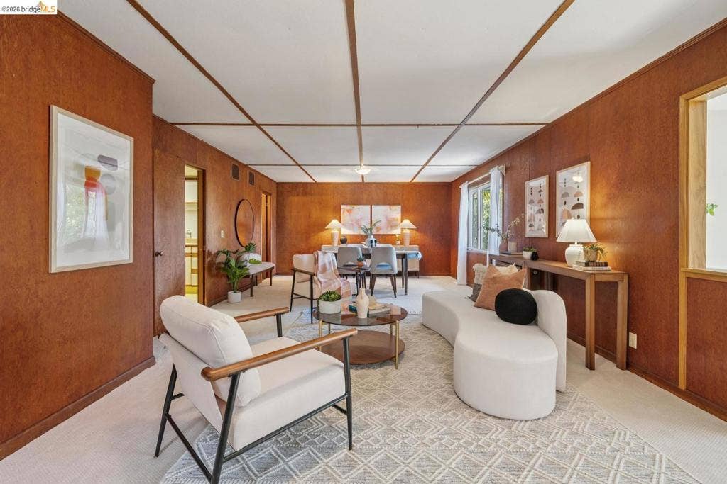 Wood panel walls, recessed window, and white ceiling with wood trim