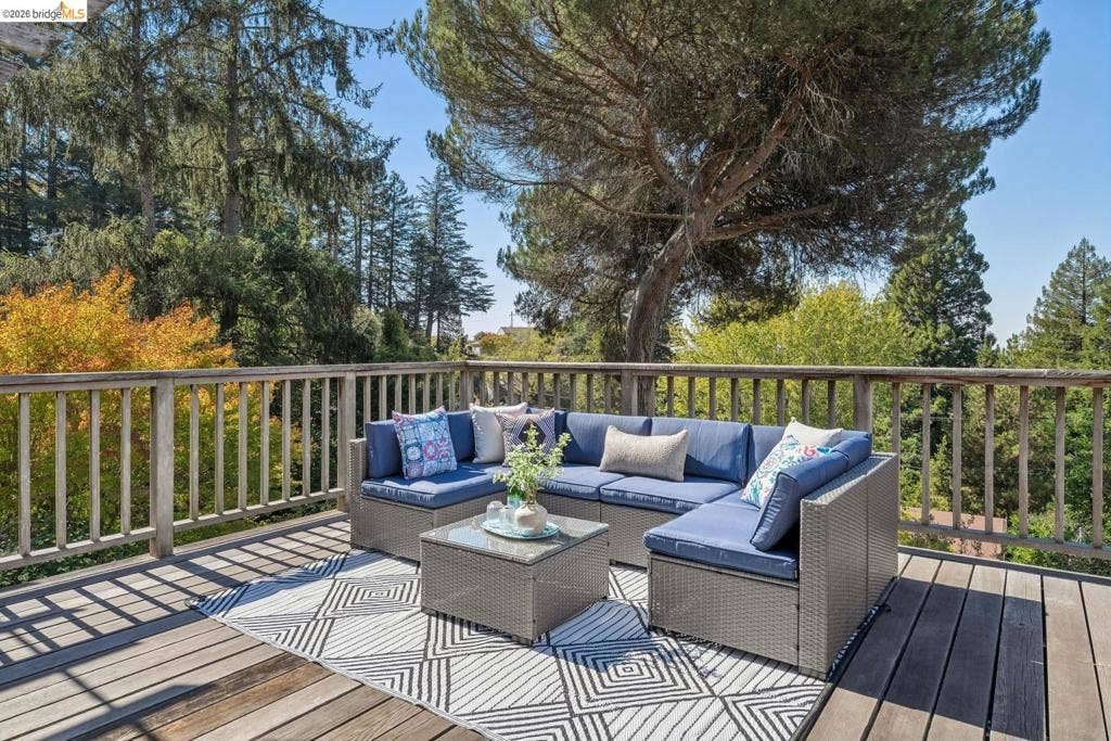 Spacious exterior deck with wood flooring and natural wood railings