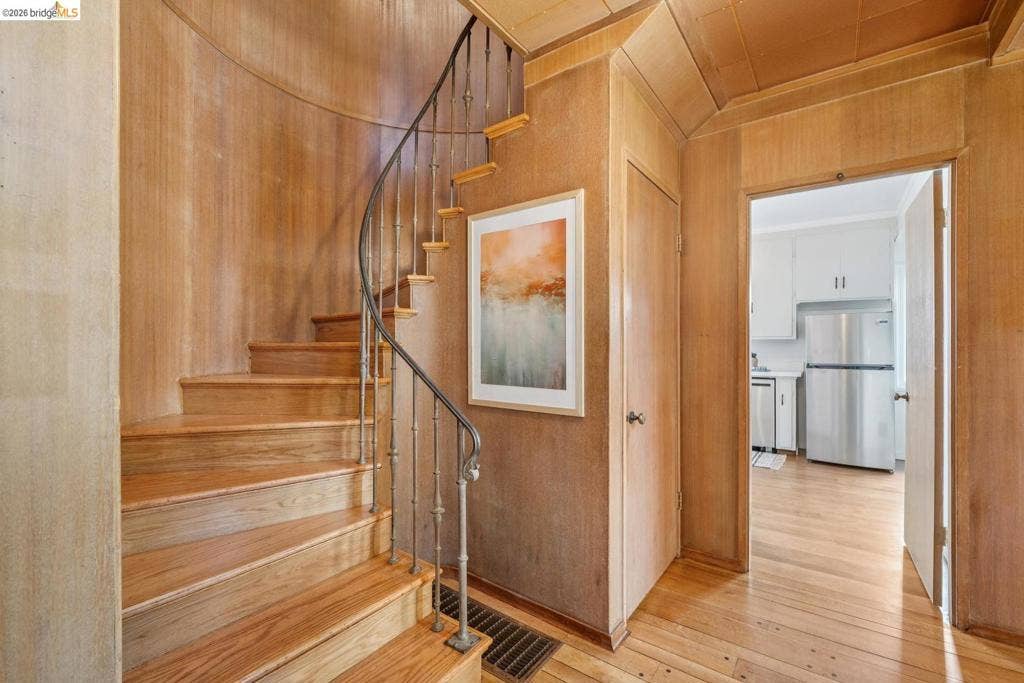 Curved staircase with wood-finish treads and metal balusters