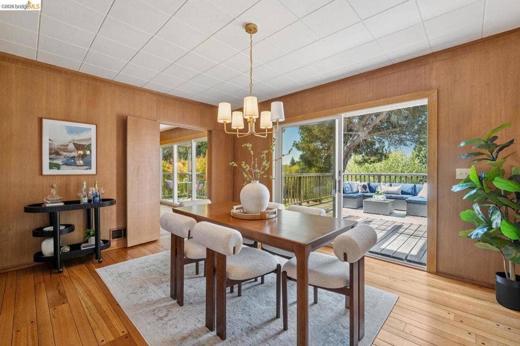 Wood-paneled walls and wood-finish flooring complement the overhead panel ceiling