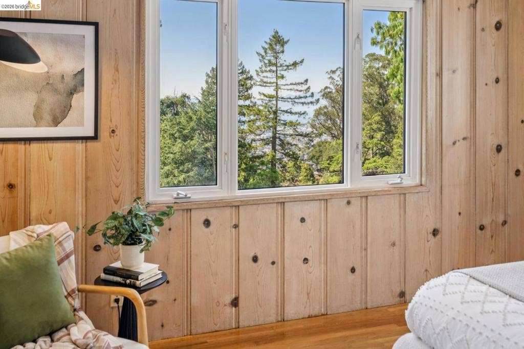 Wood-paneled walls with natural knot details, large multi-pane windows, and wood-finish flooring