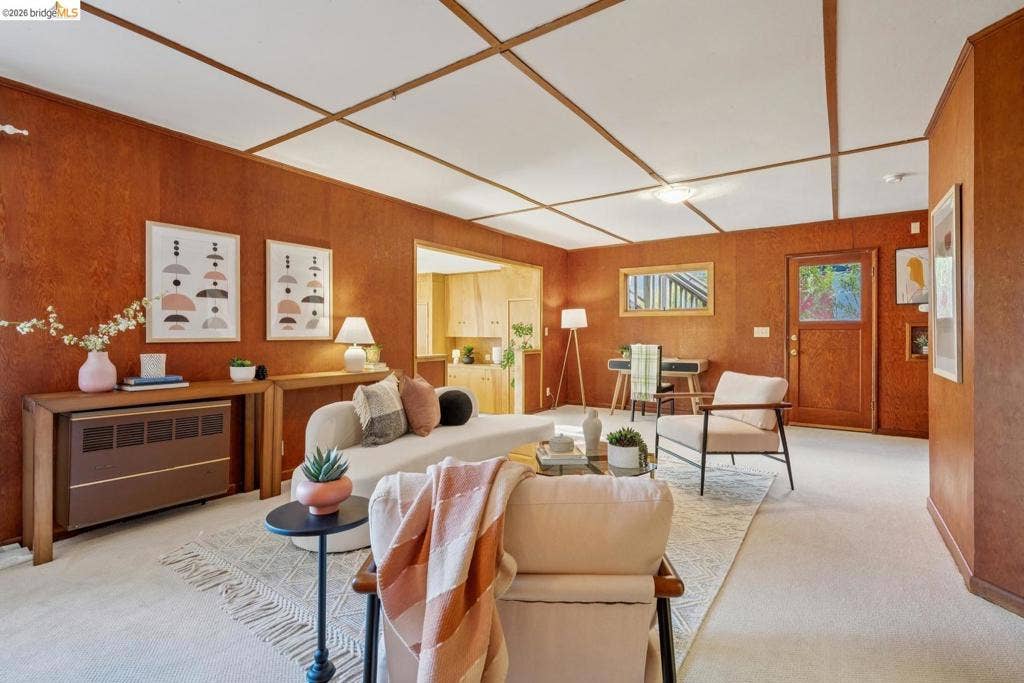 Wood-paneled walls and a white ceiling with wood trim