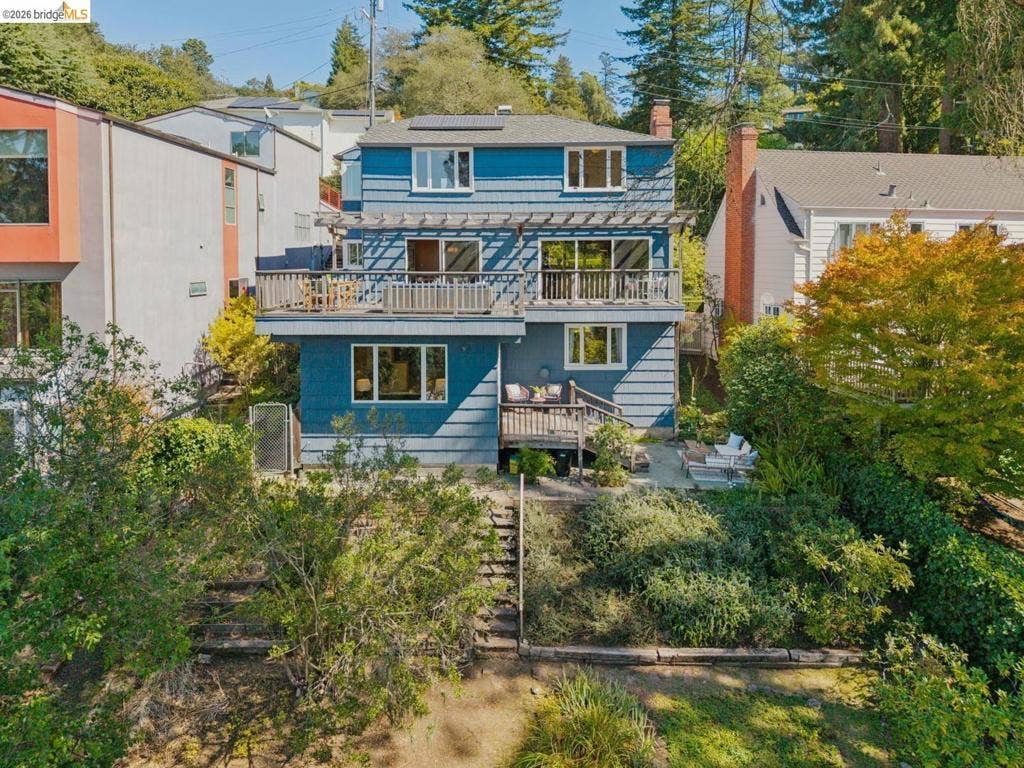 Multi-level residence featuring a blue exterior and multiple balconies