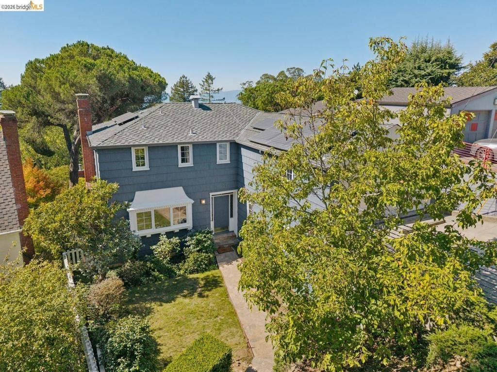 Slate blue exterior with white trim, bay window, and a gabled roof