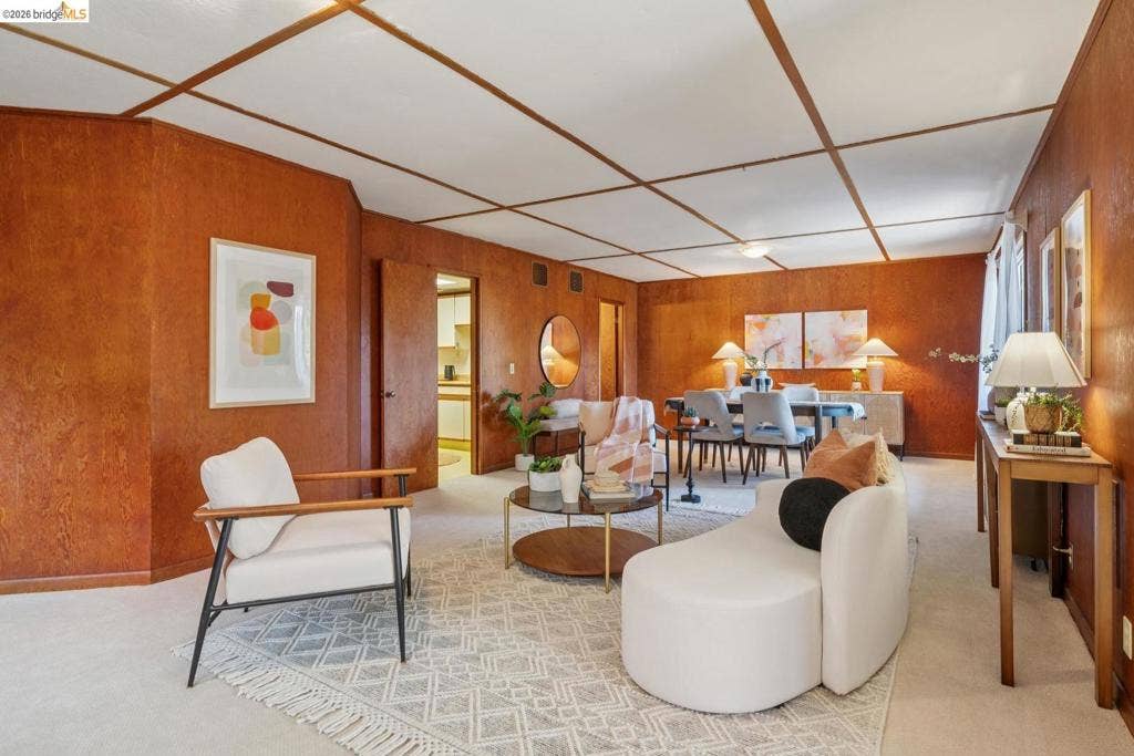 Wood-paneled walls with a grid-pattern ceiling