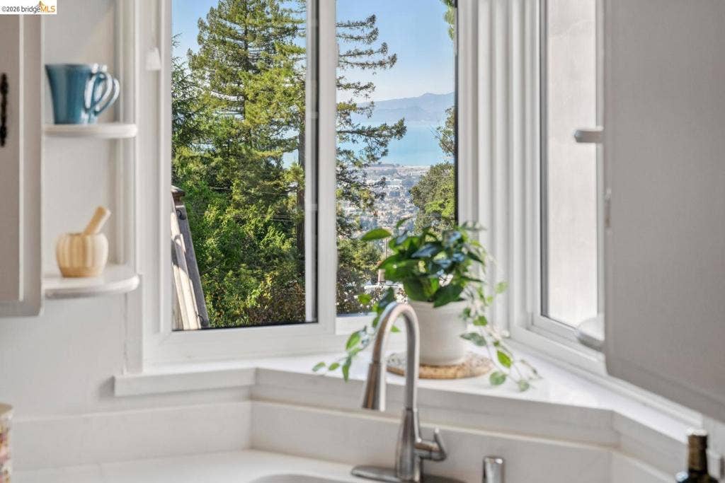 Built-in corner window featuring a white countertop and a stainless steel faucet