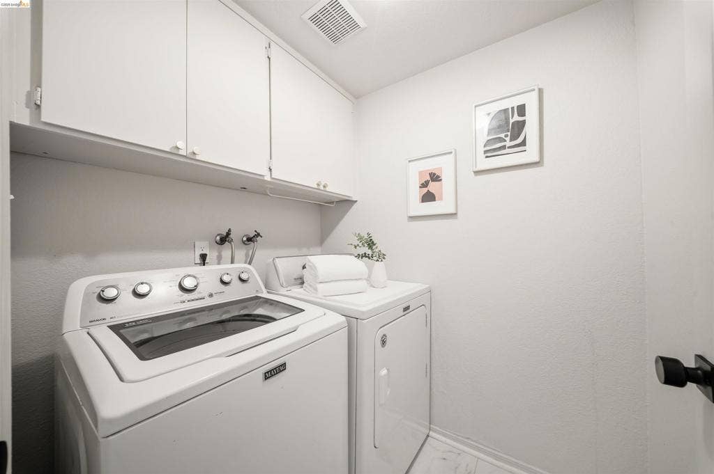 Upper cabinetry with white finish, integrated shelving, and light-toned walls