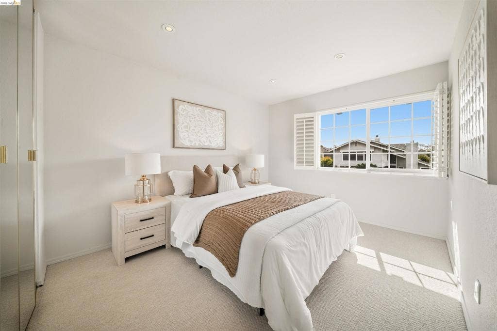 Light-filled room featuring recessed lighting and wall-to-wall carpeting