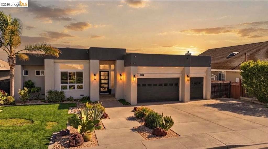 3944 Lighthouse Pl, Discovery Bay, CA 94505 Modern stucco exterior with a flat roofline, integrated two-car garage, and desert-style landscaping