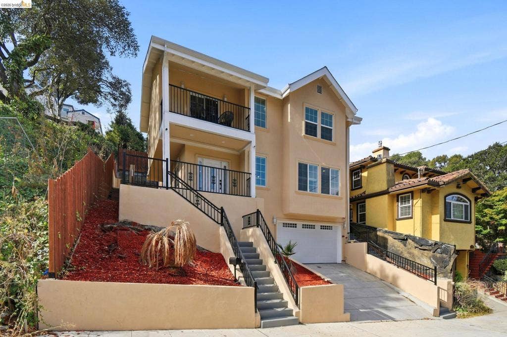 Multi-level stucco exterior with an attached garage