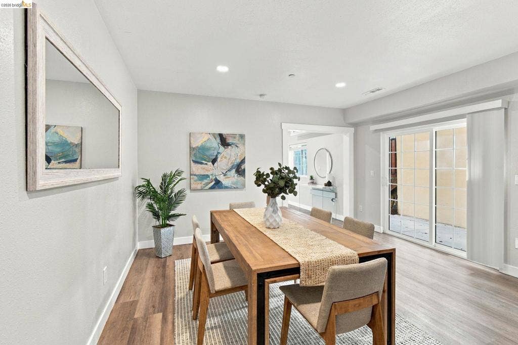 Recessed lighting illuminates the wood-finish flooring