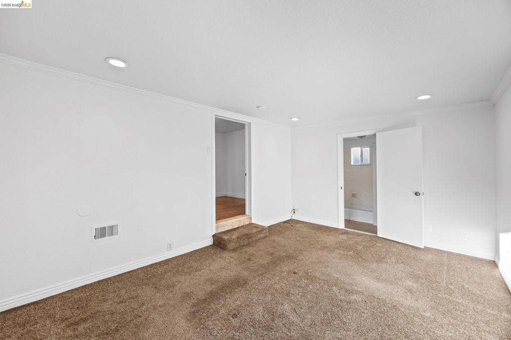 2240 Lessley Ave, Castro Valley, CA 94546 Recessed ceiling lighting, white crown molding, white baseboards, and neutral-toned carpeting