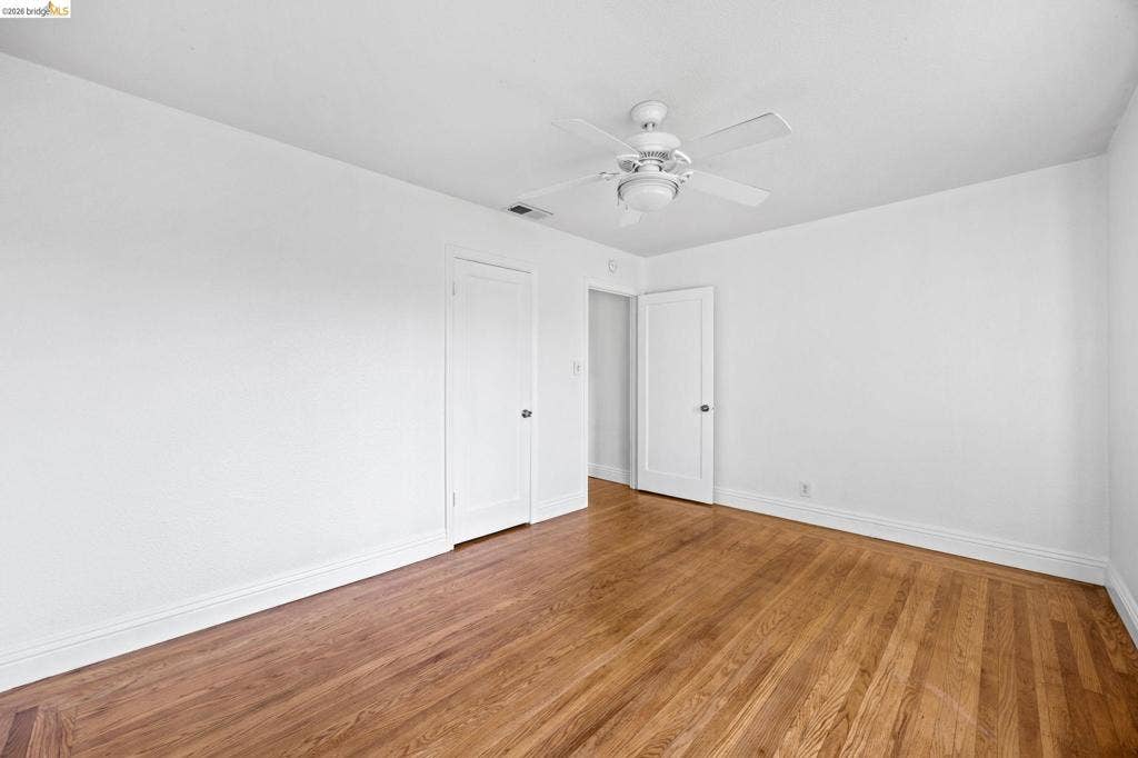 2240 Lessley Ave, Castro Valley, CA 94546 Hardwood flooring, crisp white walls, and a ceiling fan with integrated lighting