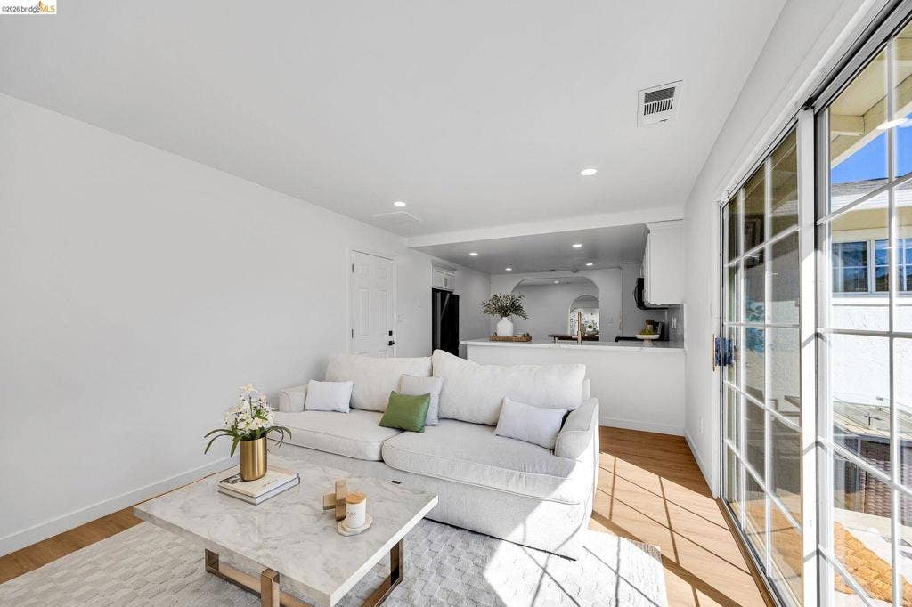 1509 Poppy Way, Antioch, CA 94509 Hardwood-style flooring throughout, recessed lighting, and a white sliding glass door