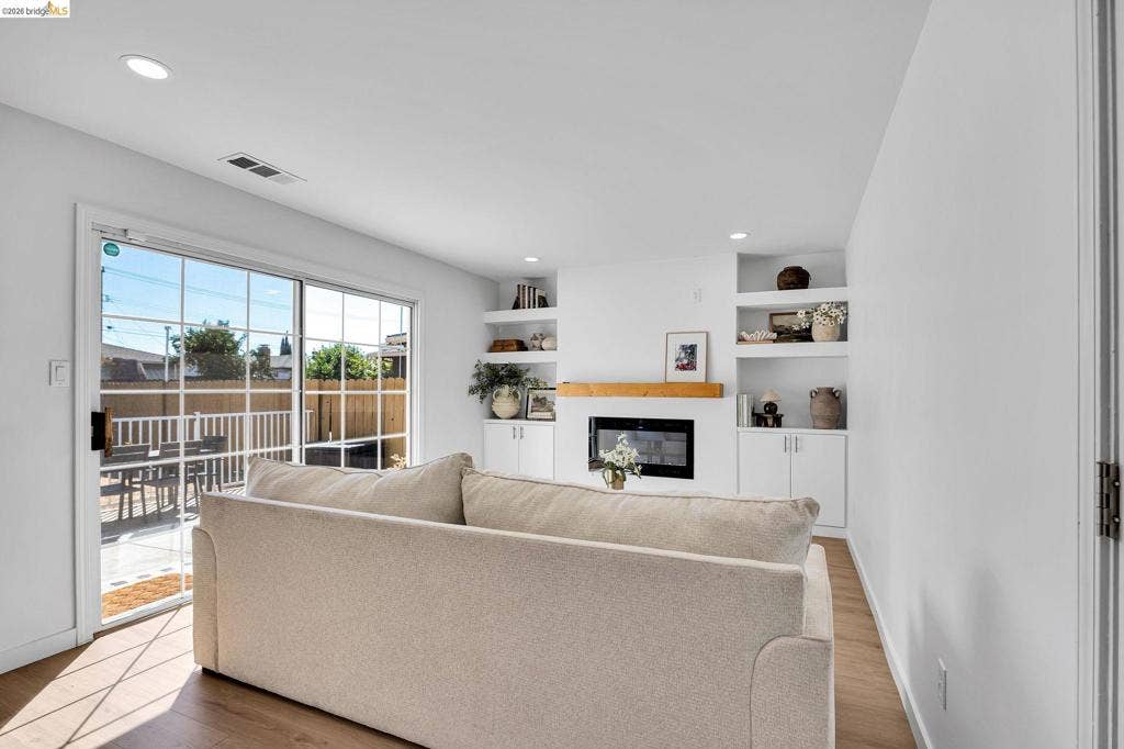 1509 Poppy Way, Antioch, CA 94509 Recessed lighting, wood-finish flooring, built-in shelving, an integrated fireplace, and a sliding glass patio door