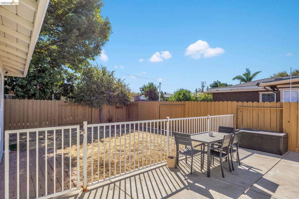 1509 Poppy Way, Antioch, CA 94509 Private backyard featuring a concrete patio, wood fencing, and a white metal fence