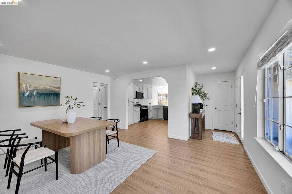 1509 Poppy Way, Antioch, CA 94509 Recessed lighting, wood-finish flooring, white walls, arched entryway, and white kitchen cabinetry