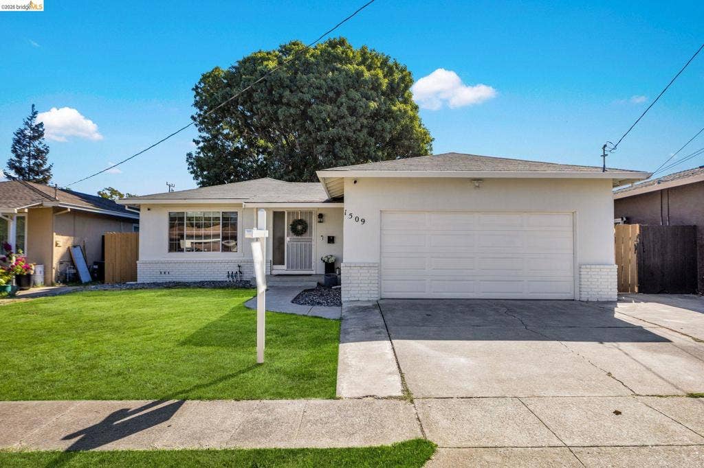 1509 Poppy Way, Antioch, CA 94509 Single-story stucco exterior with white brick accents, featuring an attached two-car garage and a manicured front lawn
