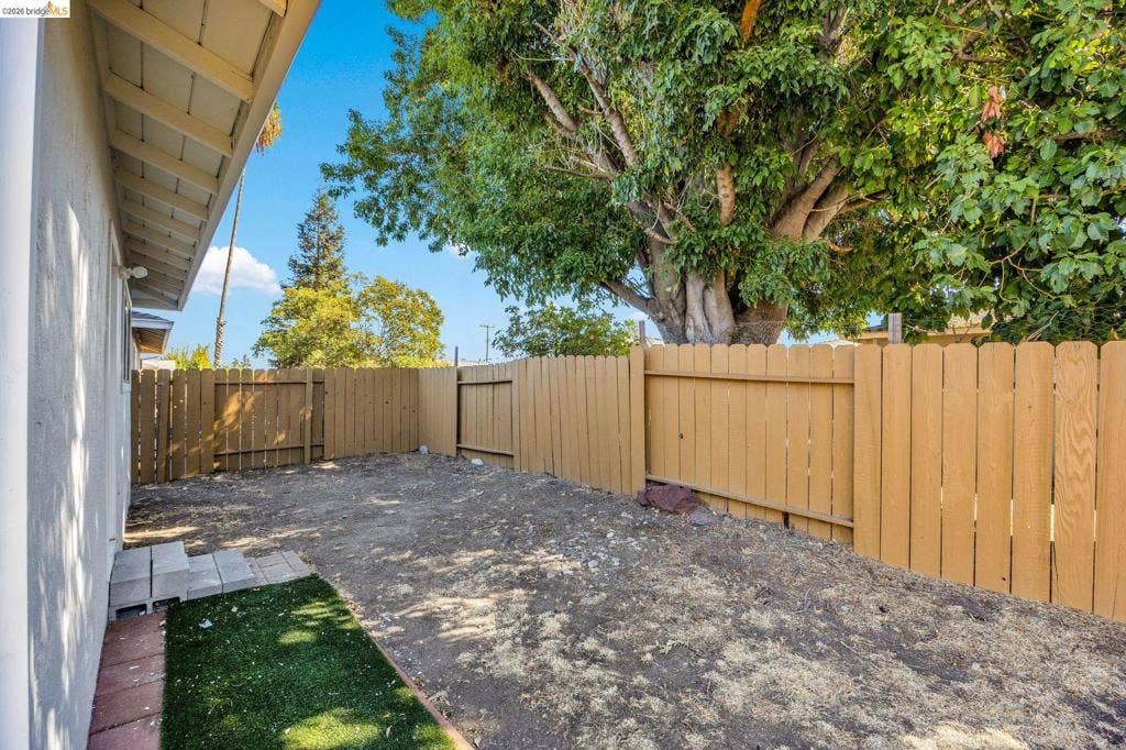 1509 Poppy Way, Antioch, CA 94509 Private outdoor space featuring wood fencing and a mature tree