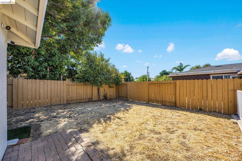 1509 Poppy Way, Antioch, CA 94509 Expansive rear yard featuring a wood fence perimeter and a brick paver patio