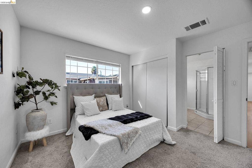 1509 Poppy Way, Antioch, CA 94509 Recessed lighting, window with exterior views, sliding closet doors, and bi-fold doors to an adjacent space with a shower enclosure
