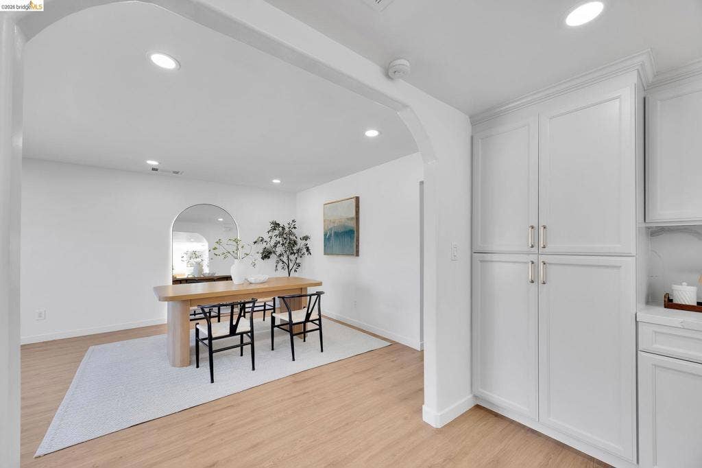 1509 Poppy Way, Antioch, CA 94509 Wood-finish flooring, recessed lighting, arched doorway, built-in cabinetry, and white shaker-style doors