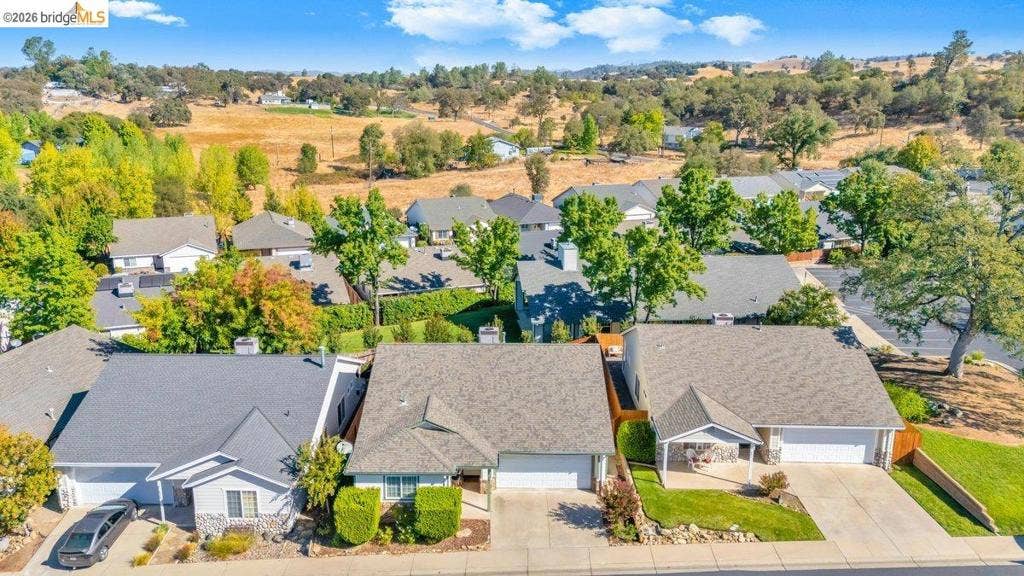 981 Country Ln, Angels Camp, CA 95222 Aerial perspective showcasing multiple homes with grey shingle roofs